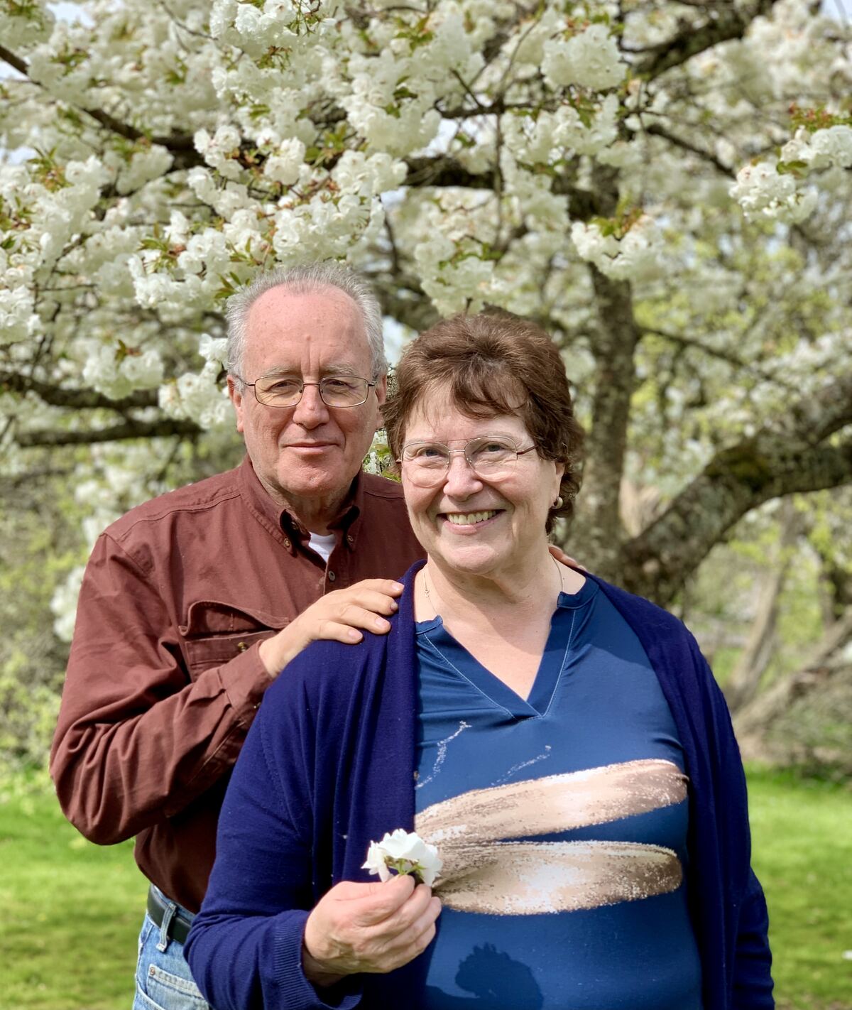Dave and Barb Sullivan in front of a flowering tree, spring 2025