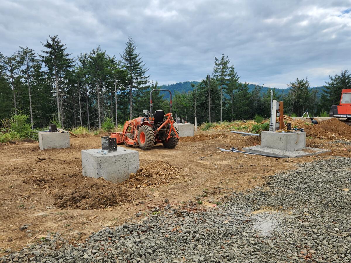The four concrete piers placed in the 20-by-20 square by tractor