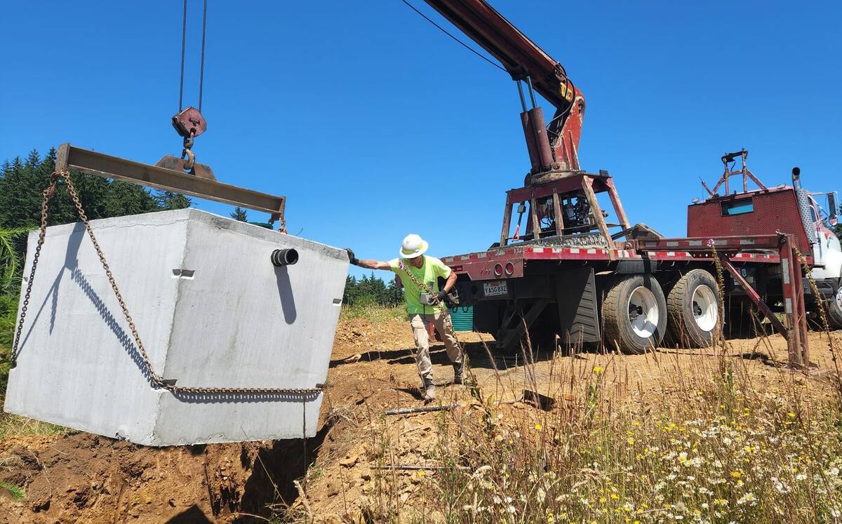 Concrete septic tank being lowered into place, July 2022
