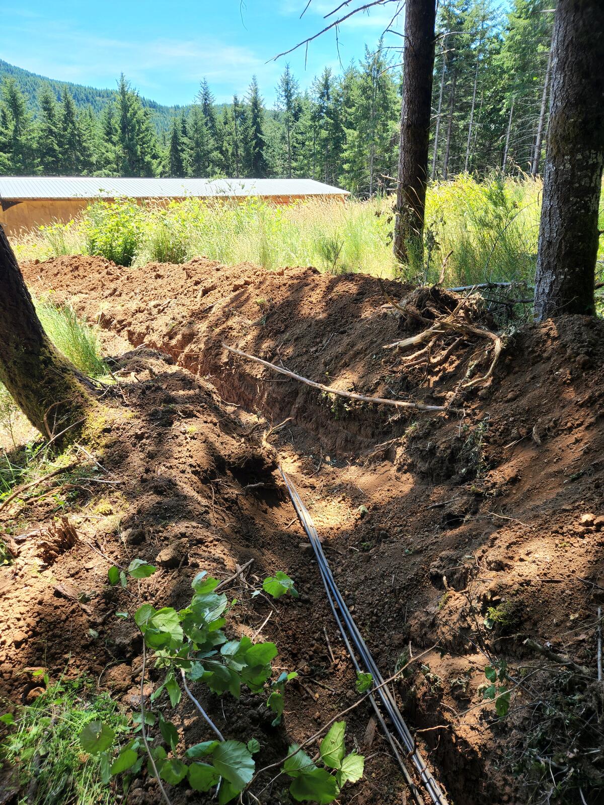 Conduit being laid in the open trench